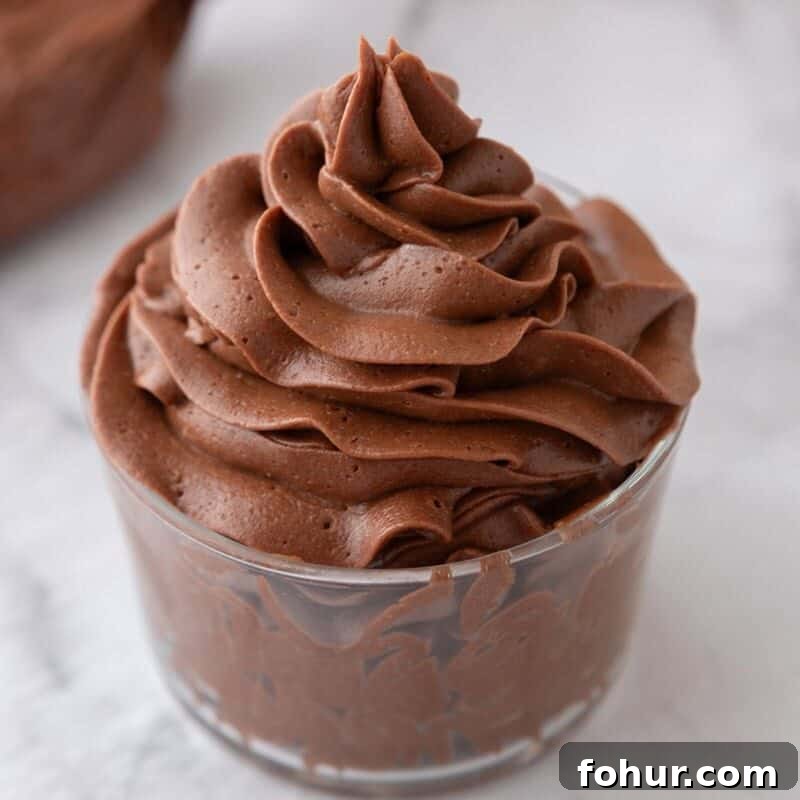 One-Bowl Chocolate Buttercream Frosting Ready in 15 Minutes 2 chocolate buttercream frosting piped into a swirl in a glass cup