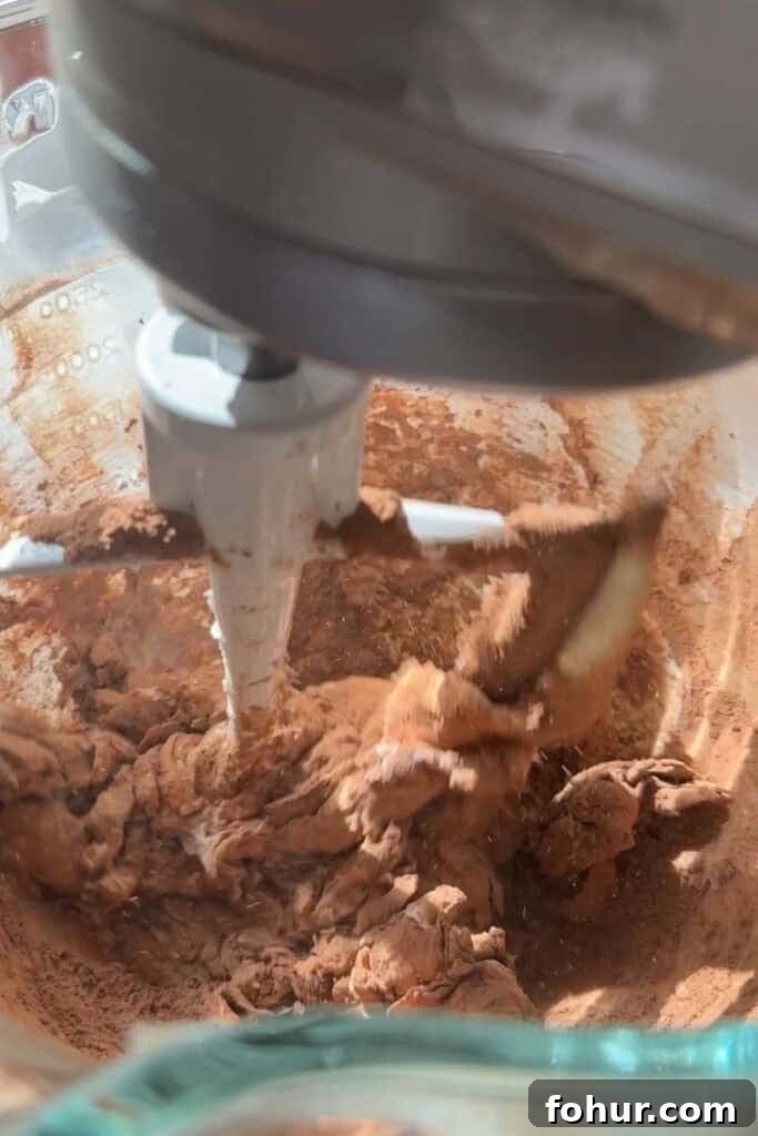 One-Bowl Chocolate Buttercream Frosting Ready in 15 Minutes 4 cocoa powder being mixed into butter in a stand mixer