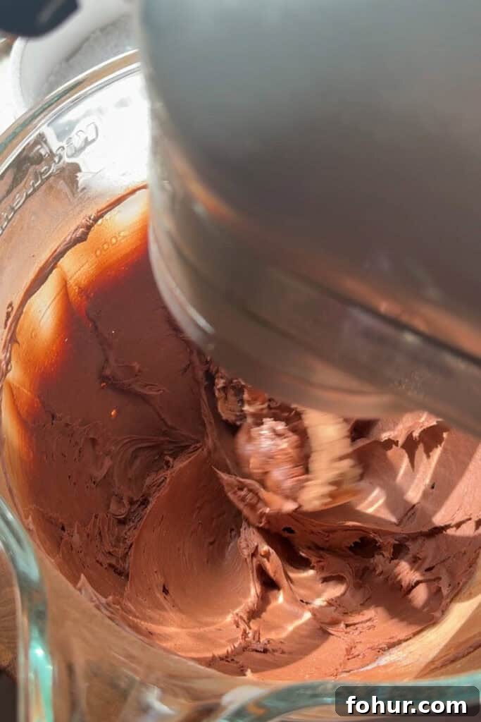 One-Bowl Chocolate Buttercream Frosting Ready in 15 Minutes 5 chocolate frosting coming together in a stand mixer bowl