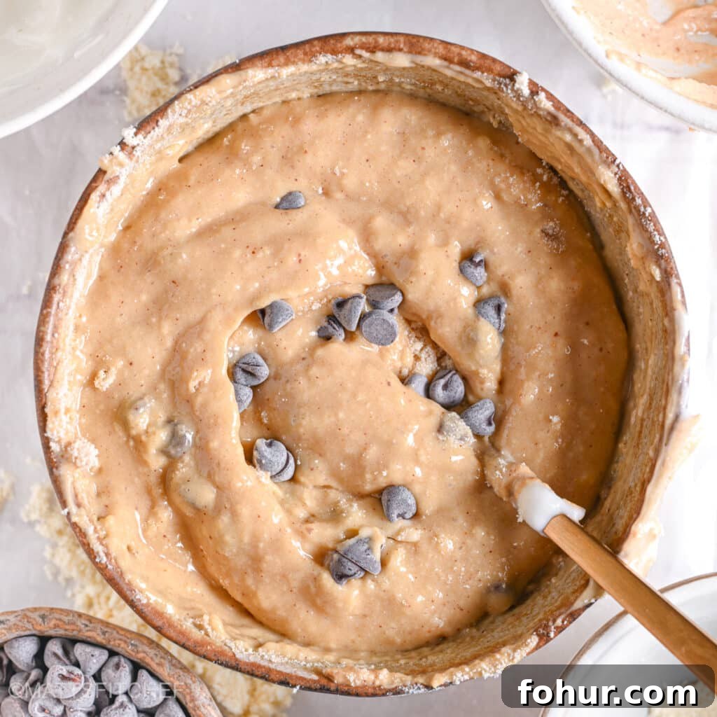No-Bake Edible Protein Cookie Dough Recipe 7 Thick, gooey, and delicious-looking protein cookie dough with chocolate chips, ready to eat.