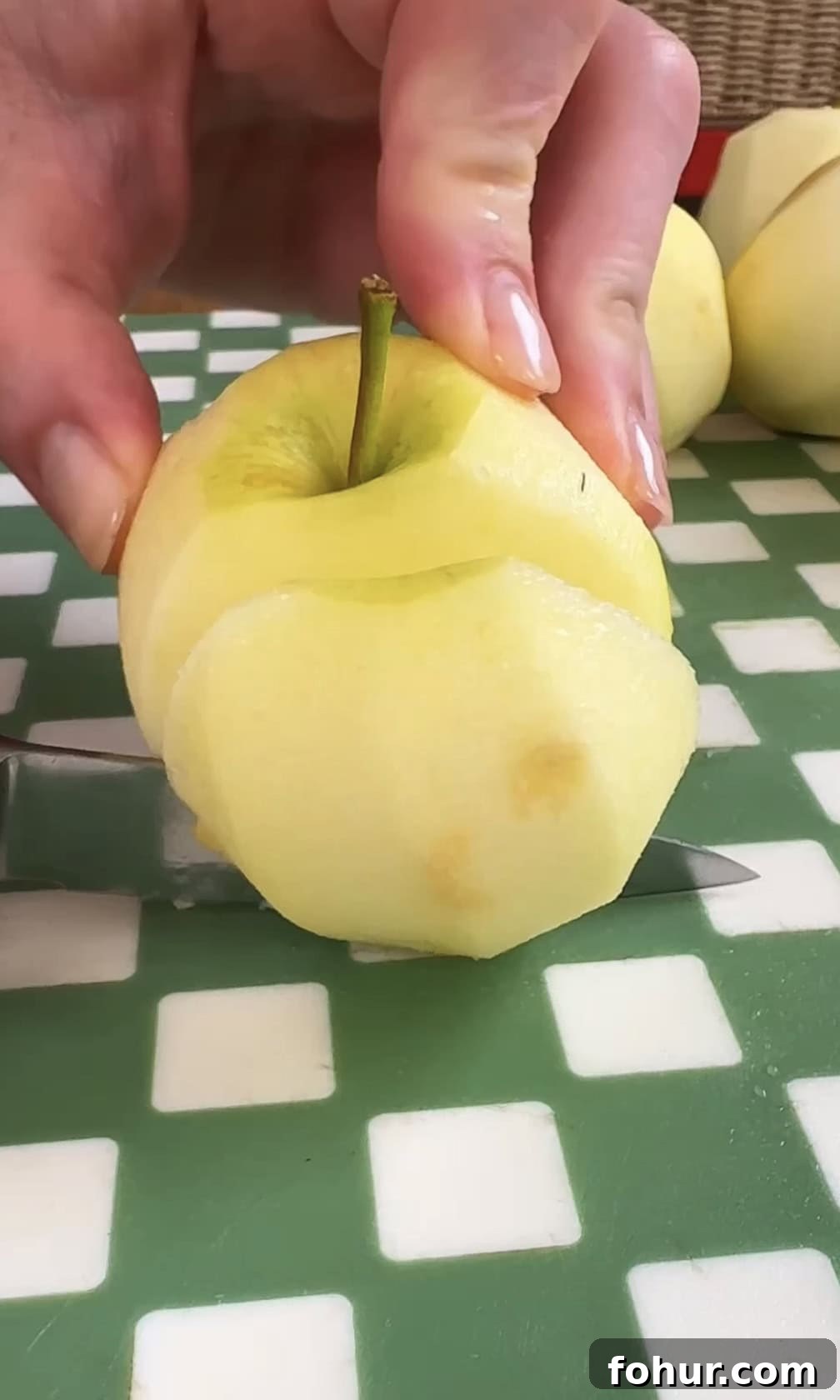 Slicing apples with knife.