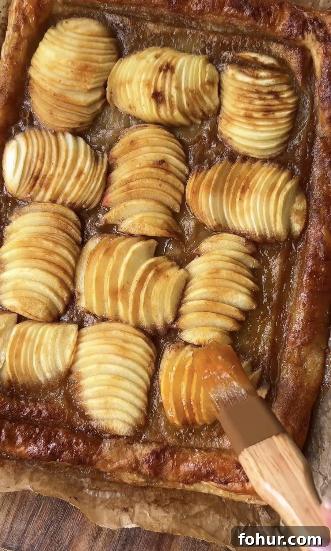 brushing apple tart with apricot jam.