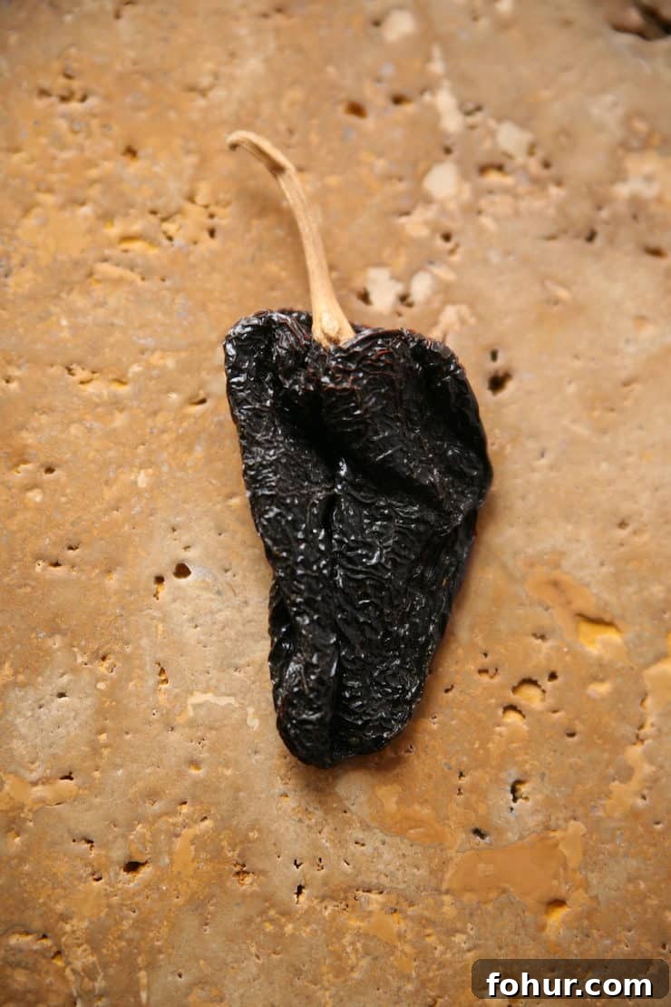 Mexican Chiles: Fresh and Dried Pepper Varieties 14 Dried ancho chile pepper, the dried form of a poblano chile with a sweet, earthy flavor used in mole, adobo, and enchilada sauce.