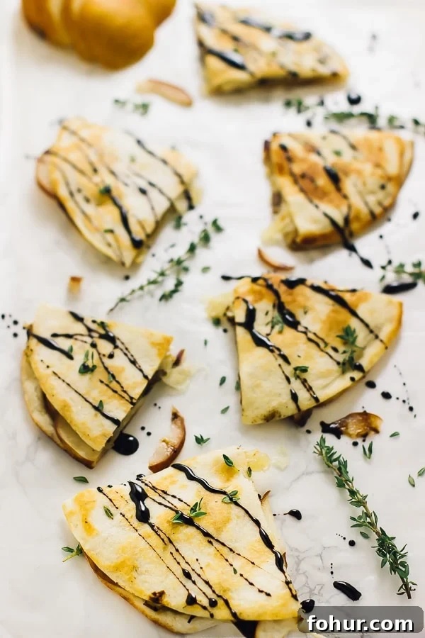 Vegan Pear and Brie Quesadilla Recipe with Caramelized Onions 3 Overhead shot of quesadillas drizzled with a balsamic glaze.