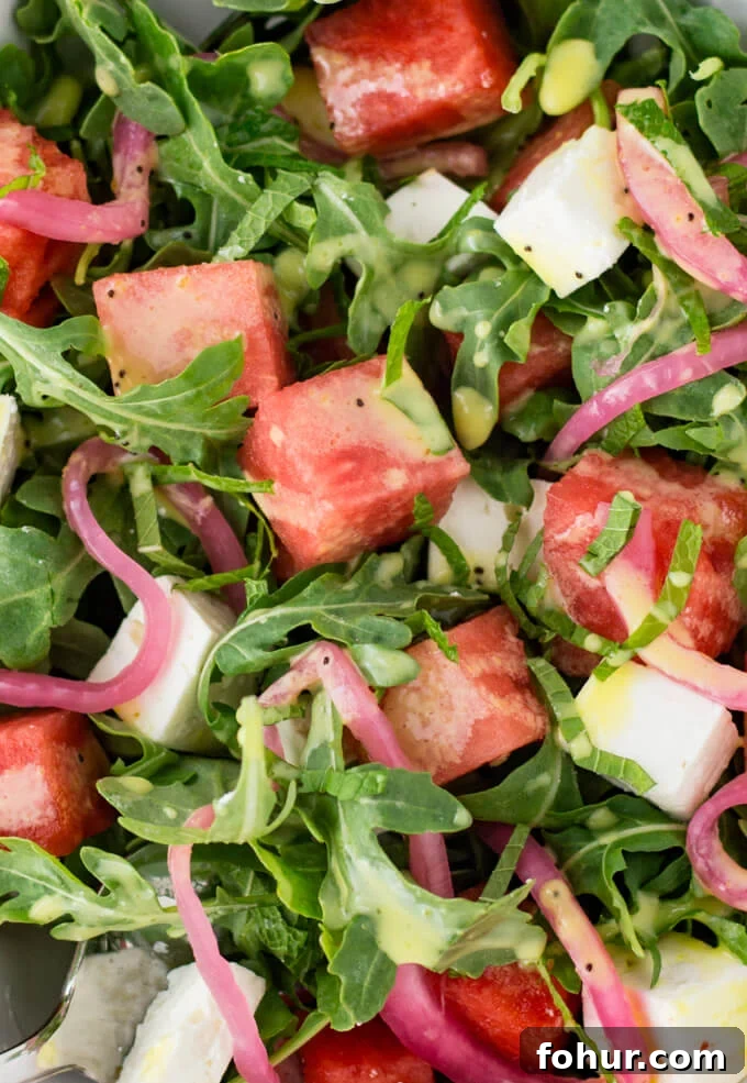 Watermelon salad with pickled onions, feta cheese and arugula.