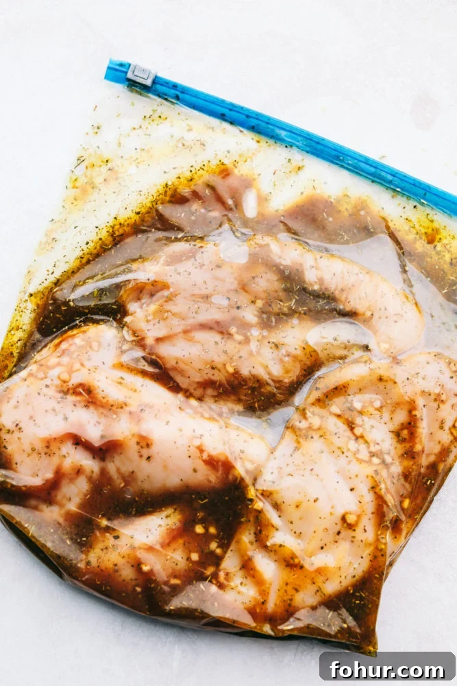 Chicken marinating in a ziploc bag.