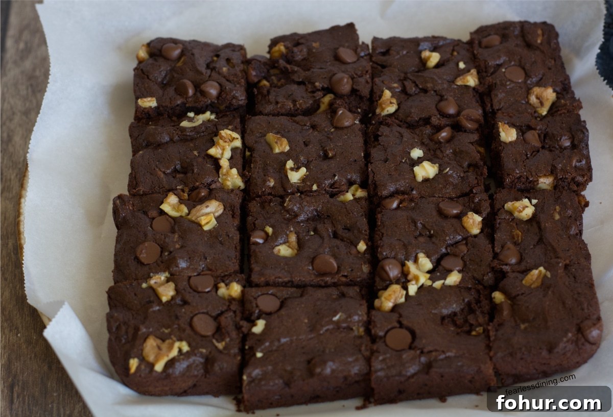 Fudgy Gluten-Free Chocolate Walnut Cookie Bars 5 Baked chocolate walnut cookie bars on parchment paper.