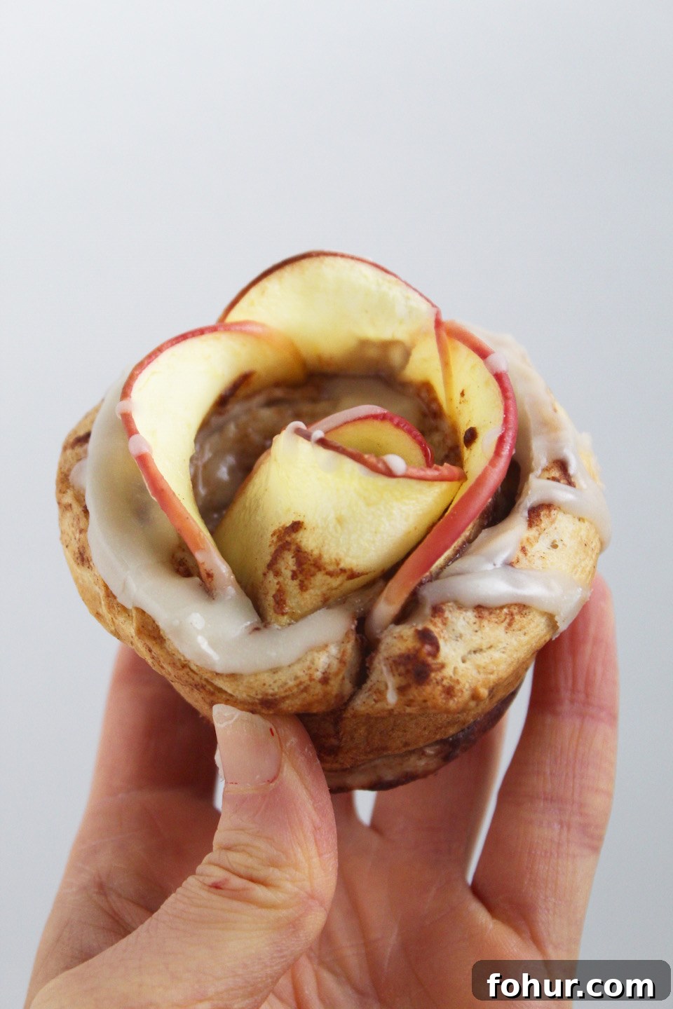 Cinnamon Roll Apple Roses Recipe -- Edible roses made with tart apple slices wrapped up in sweet and gooey cinnamon rolls. Such an easy and impressive treat for the holidays!