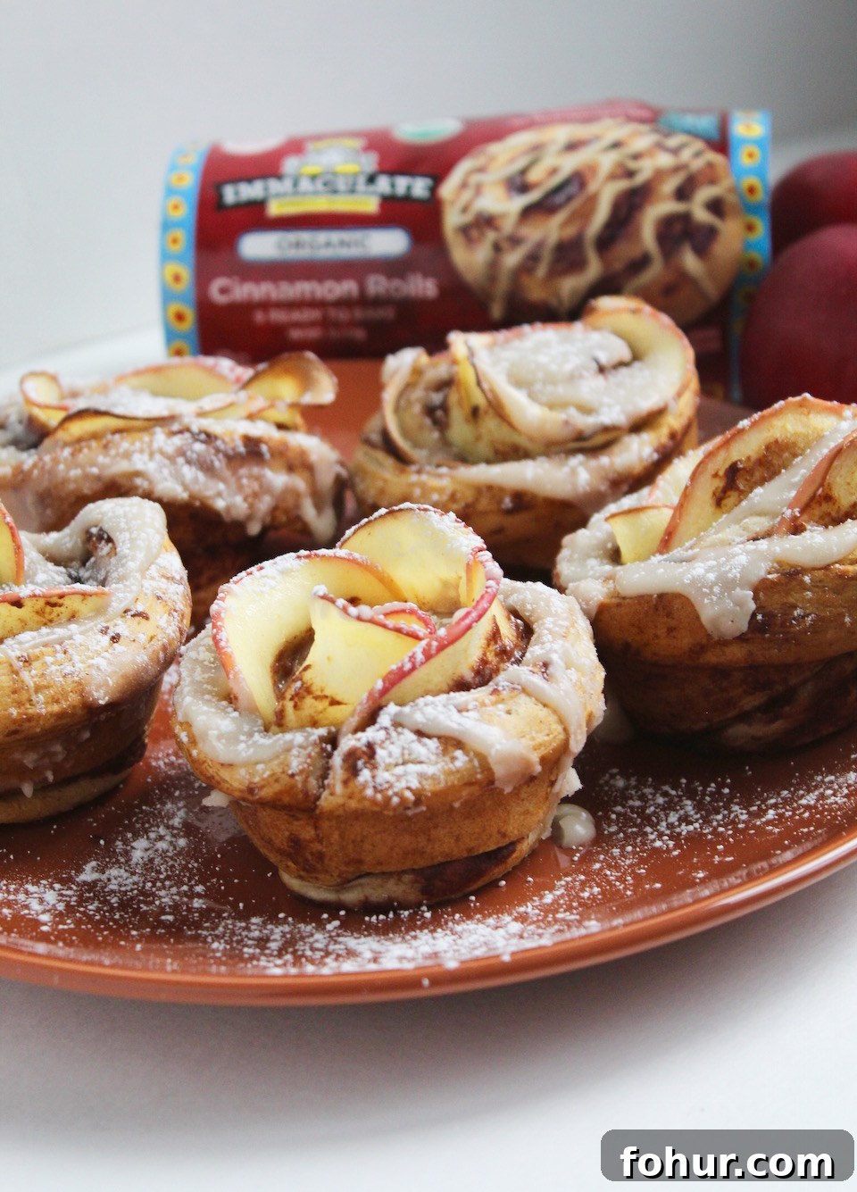 Finished cinnamon roll apple roses dusted with powdered sugar