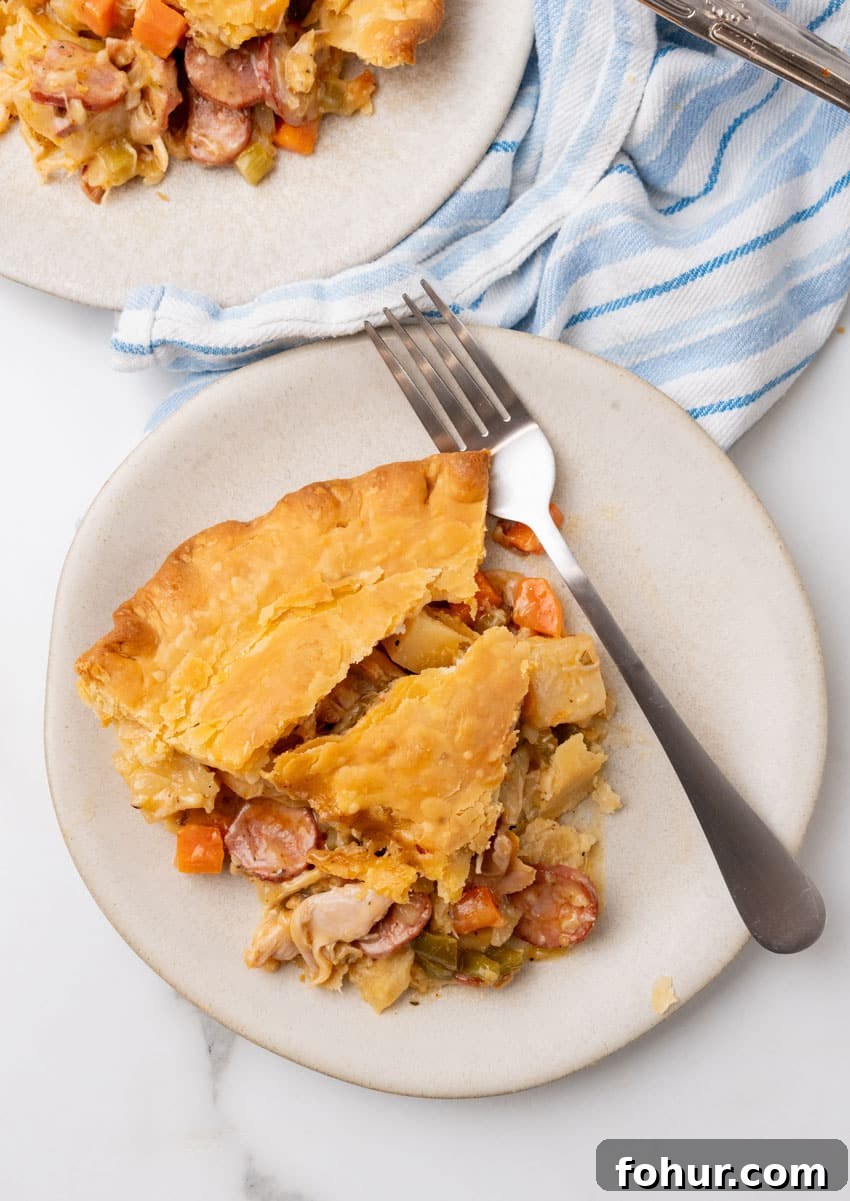 Smoked Sausage and Chicken Pot Pie Recipe with Flaky Crust 6 a slice of smoked sausage and chicken pot pie on a small white plate
