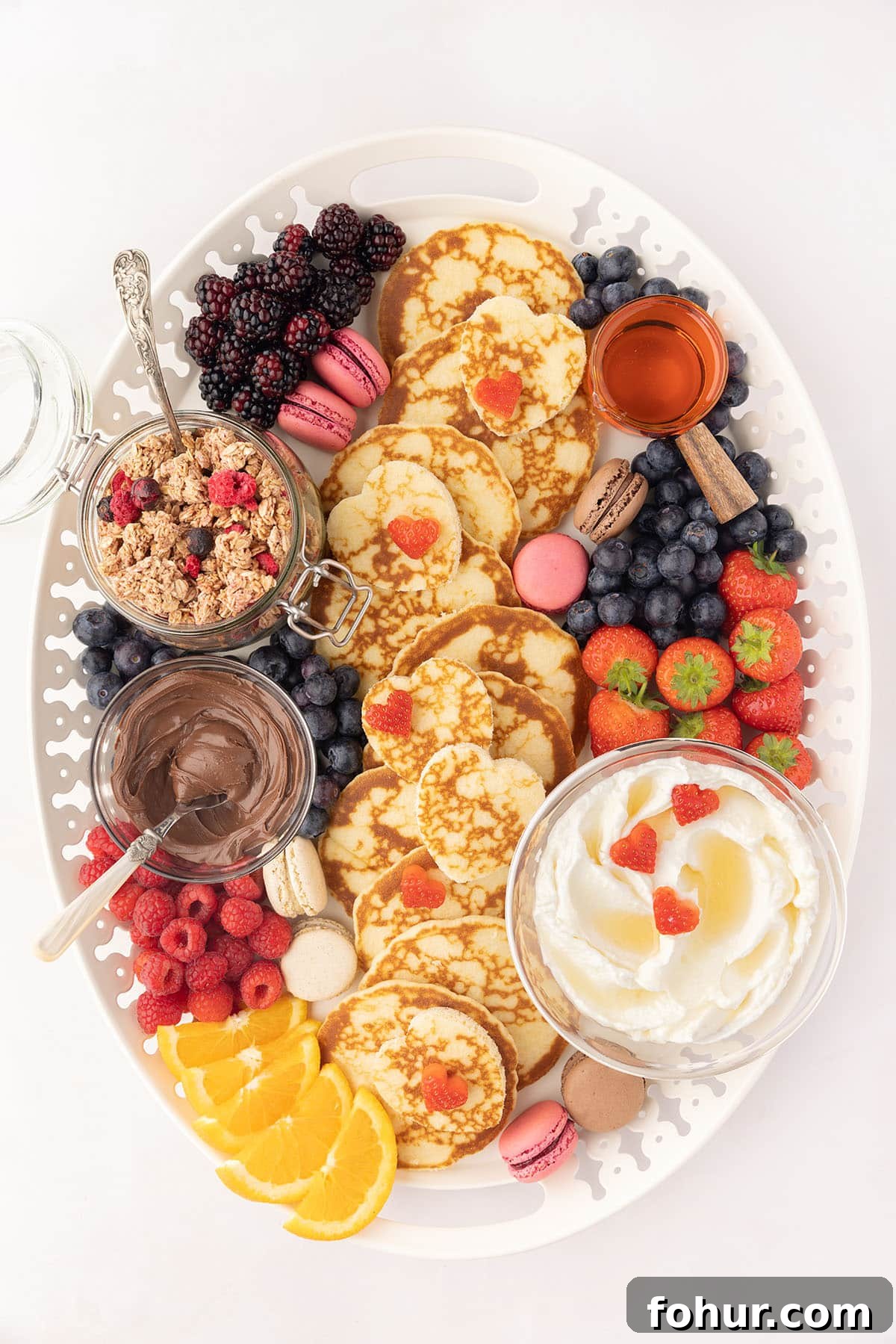 Valentine's Day Charcuterie Board for Two 8 Garnishing breakfast charcuterie board with strawberries.