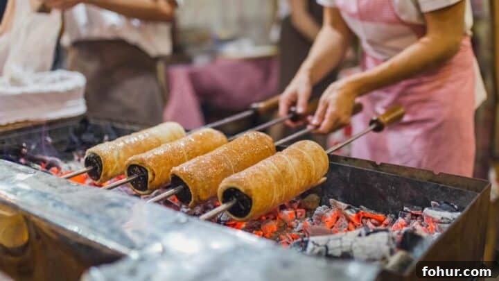 How to Make Authentic Hungarian Chimney Cake (Kürtőskalács) 3 cooking chimney cake over hot coals as done in the streets