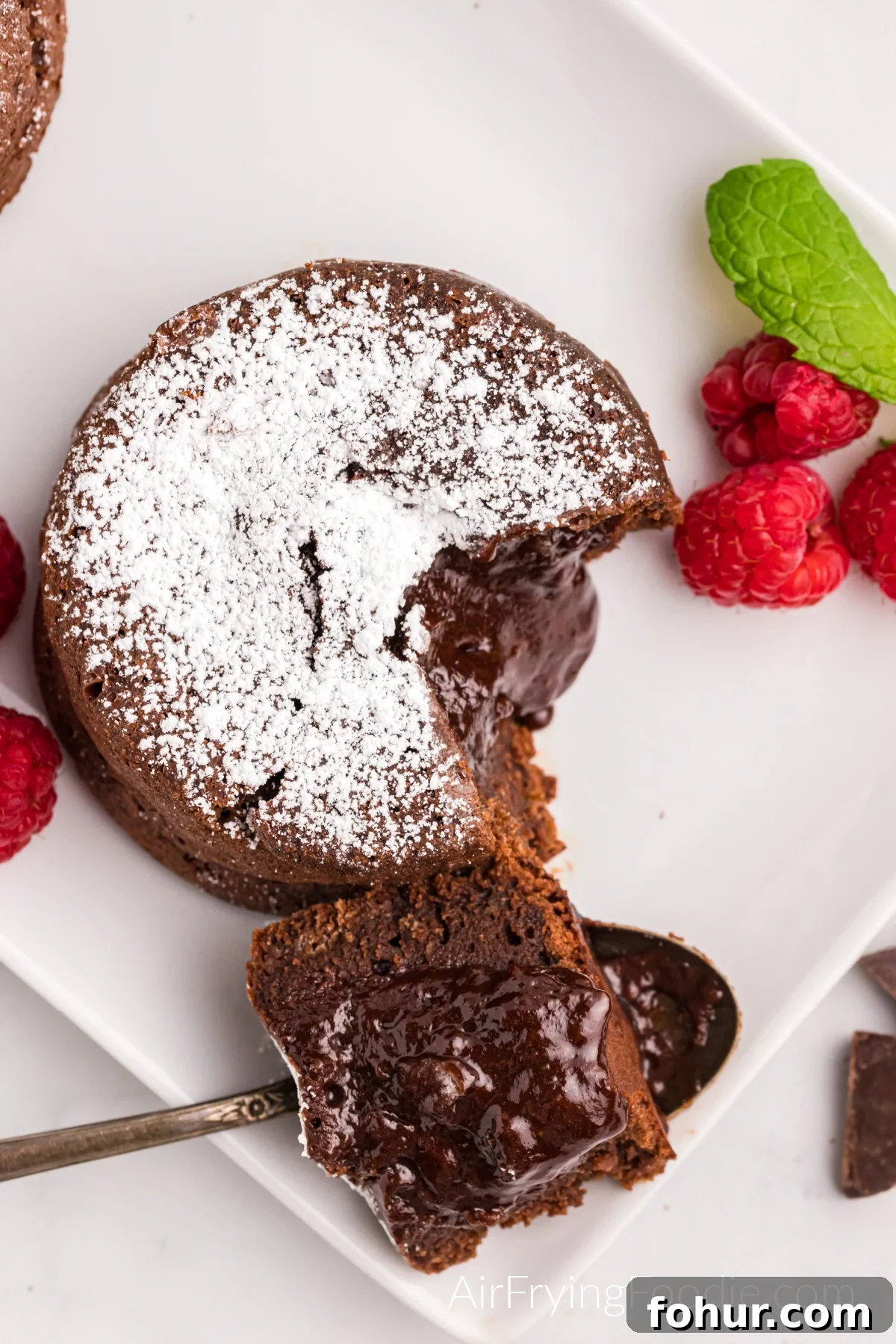 Bite shot removed from lava cakes made in the air fryer, and dusted with confectioner's sugar. 