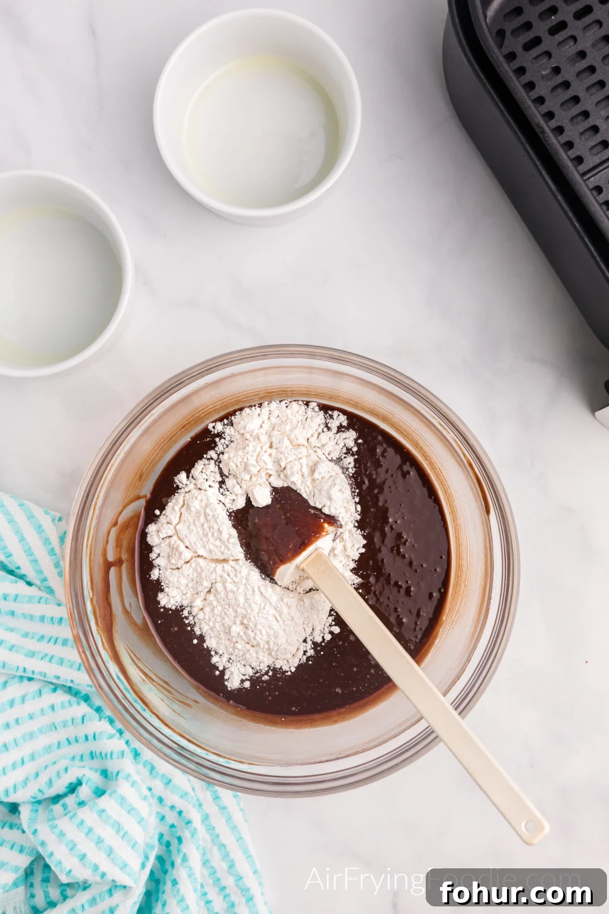 Flour being added to the chocolate mixture.