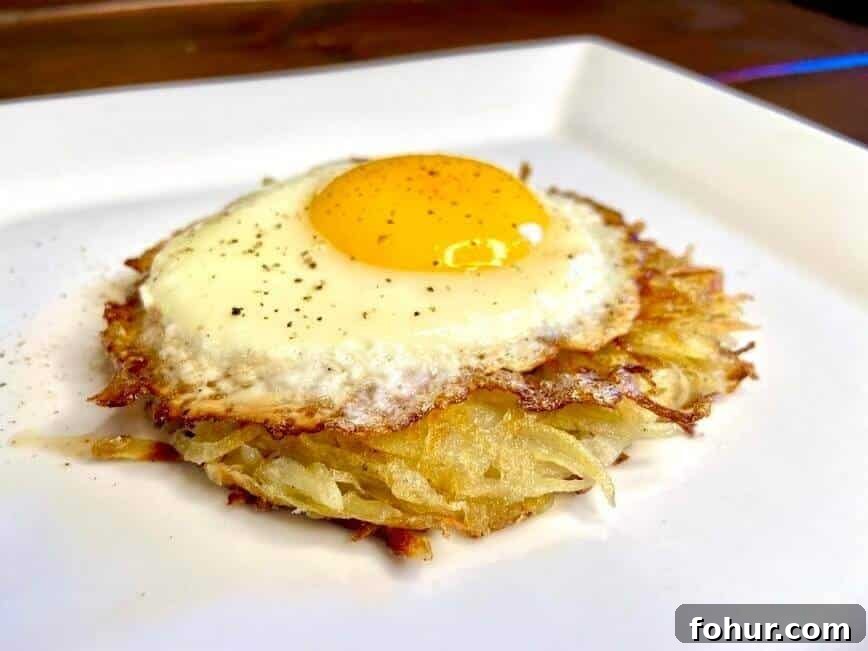 Crispy Buttery Hash Browns: How to Make Them 12 Sunny side up egg on top of a hash brown patty.