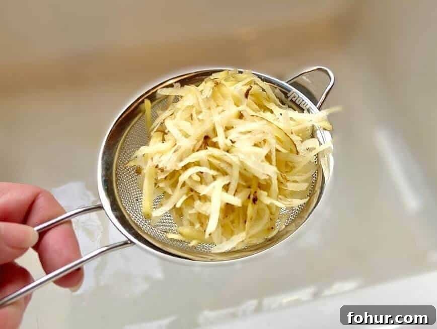 Crispy Buttery Hash Browns: How to Make Them 5 Straining shredded potatoes in a fine mesh sieve.