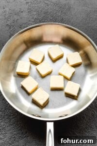 How to Brown Butter Without Burning It 6 Skillet with a stick of butter cut up into pieces.