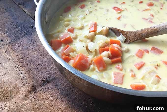 Creamy Saffron Chickpea Stew Recipe 9 Stirring a silky and creamy vegetarian soup