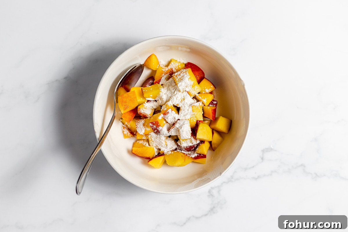 Moist Homemade Peach Bread Recipe with Cinnamon Glaze 5 Chopped peaches and flour in small white bowl.