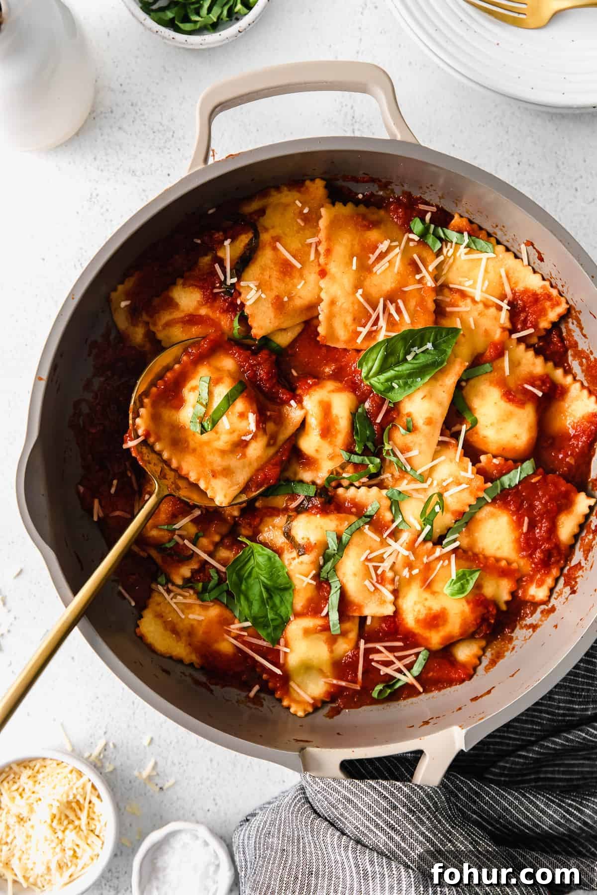 Cheese ravioli with marinara and basil homemade cheese ravioli in a skillet topped with marinara and fresh basil