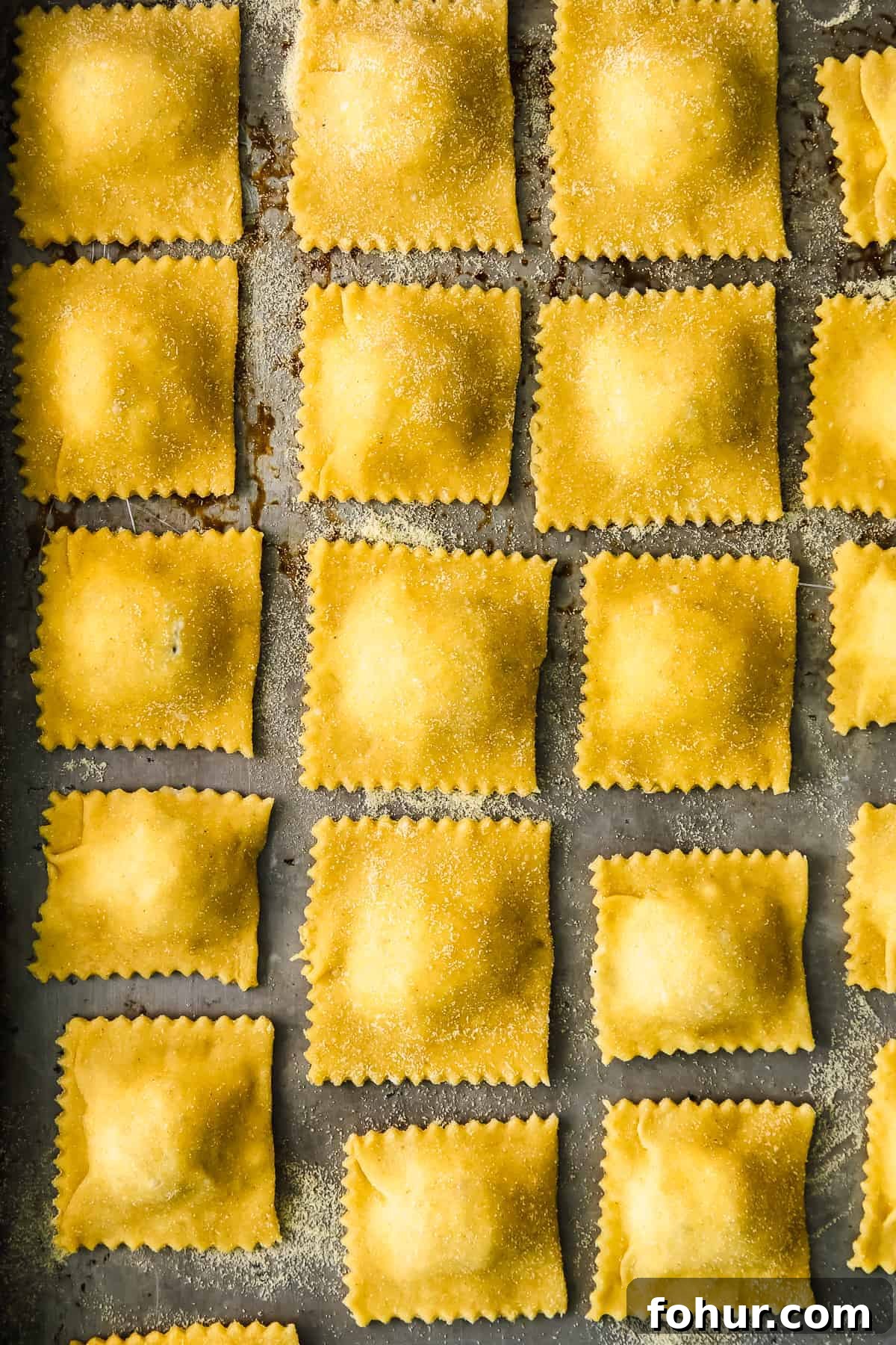 Ravioli drying on a baking sheet homemade cheese ravioli on a baking sheet