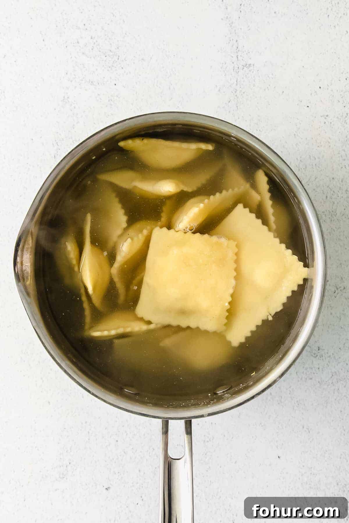 Cooking homemade cheese ravioli homemade cheese ravioli in a pot of boiling water