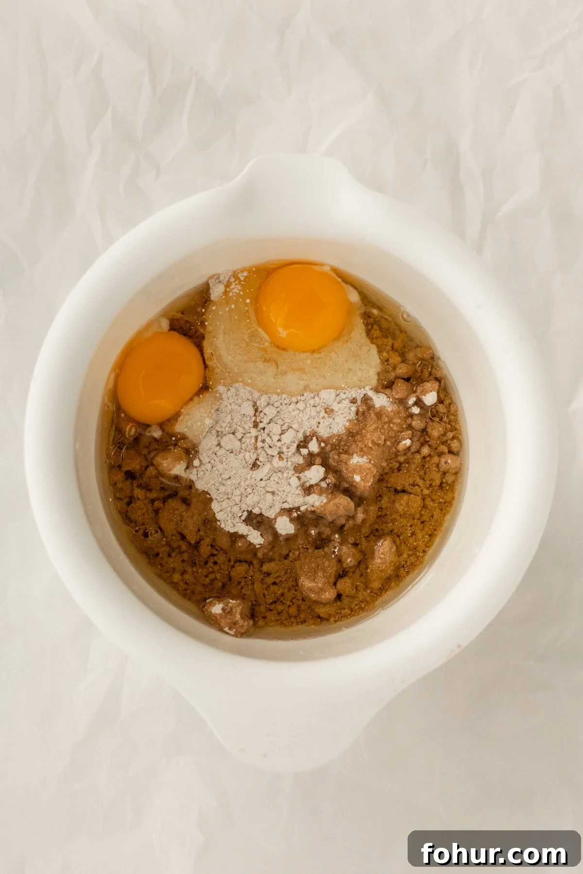 3-Ingredient Spice Cake Mix Cookies Recipe 6 eggs, oil and cake mix in a mixing bowl.
