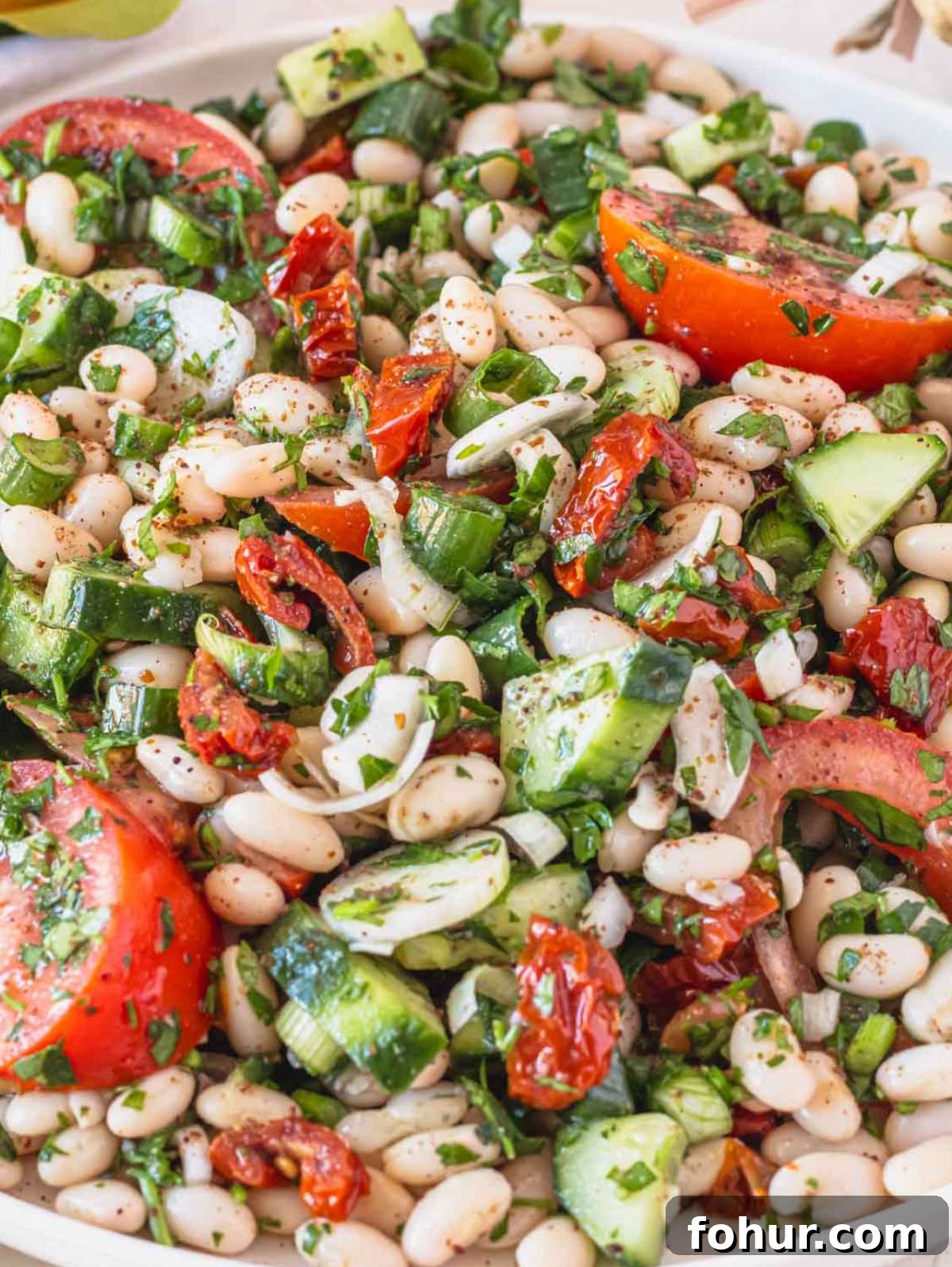 Hearty Mediterranean White Bean Salad with Herbs and Lemon 2 Close up of dense white bean salad with honey mustard dressing and fresh herbs.