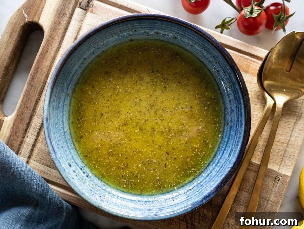 Hearty Mediterranean White Bean Salad with Herbs and Lemon 4 Step 1 Whisking olive oil mustard and honey to make dressing for white bean salad.