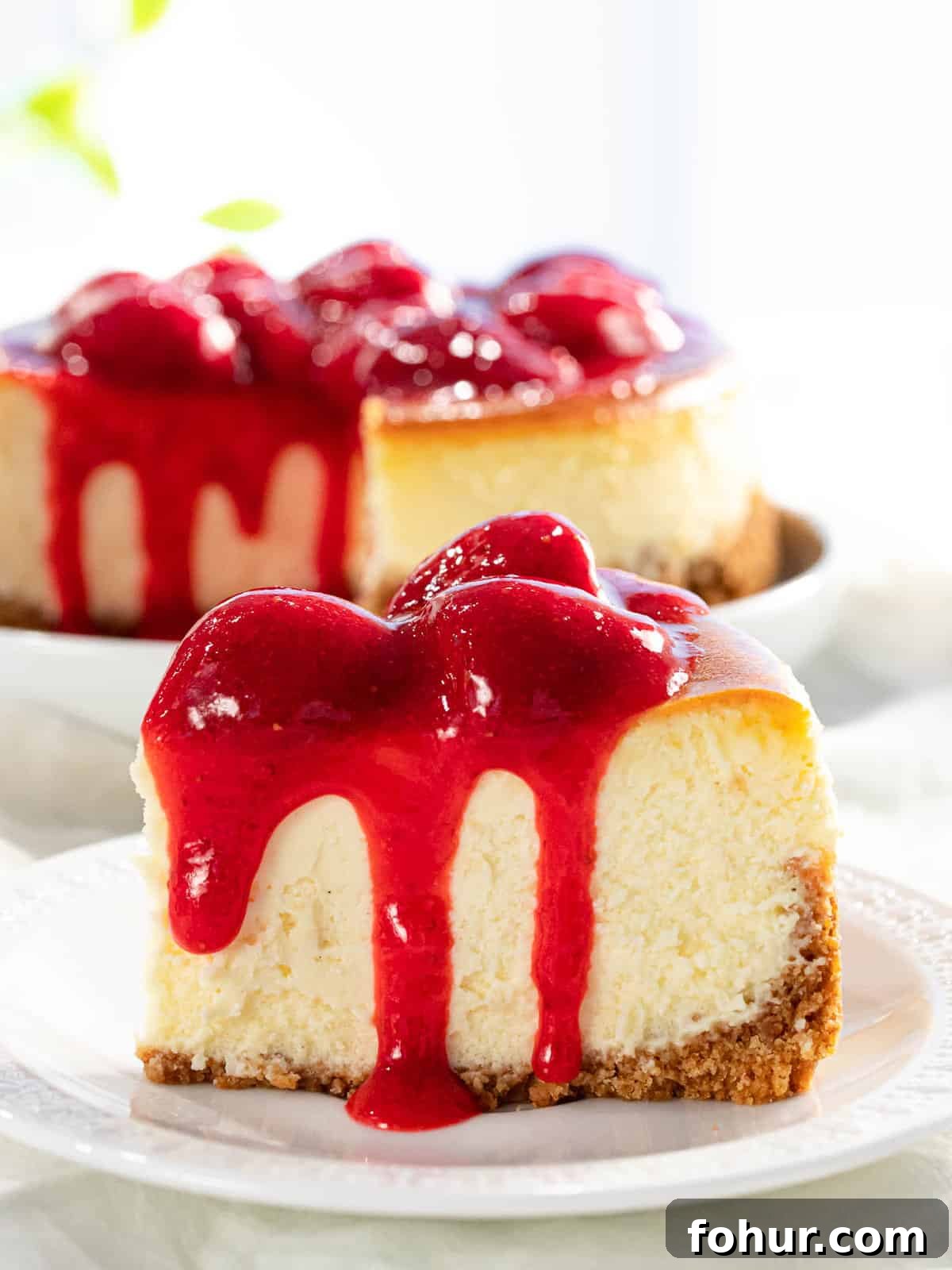 Strawberry sauce on top of cheesecake.