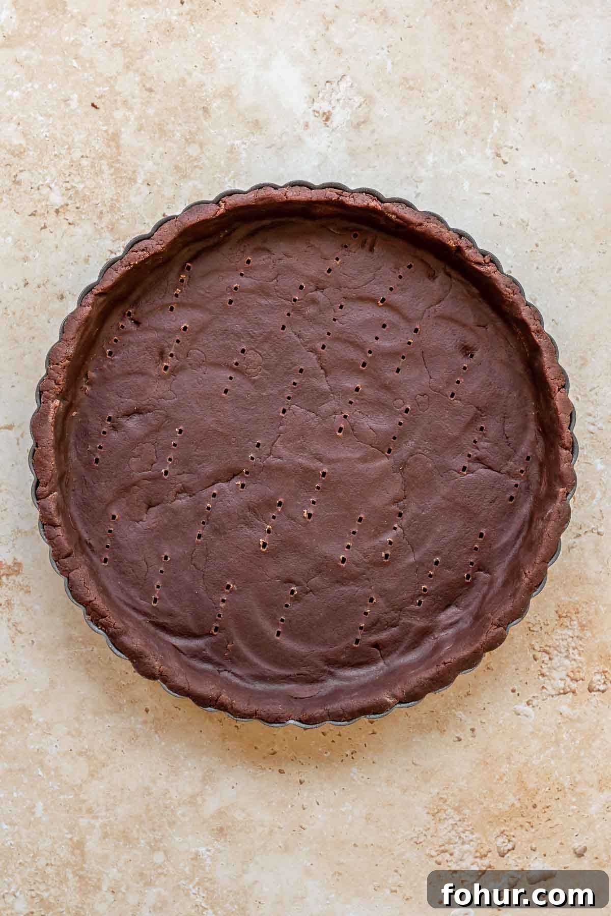 From Scratch Chocolate Raspberry Tart Recipe 4 Chocolate sweet tart crust in a tart pan before baking.