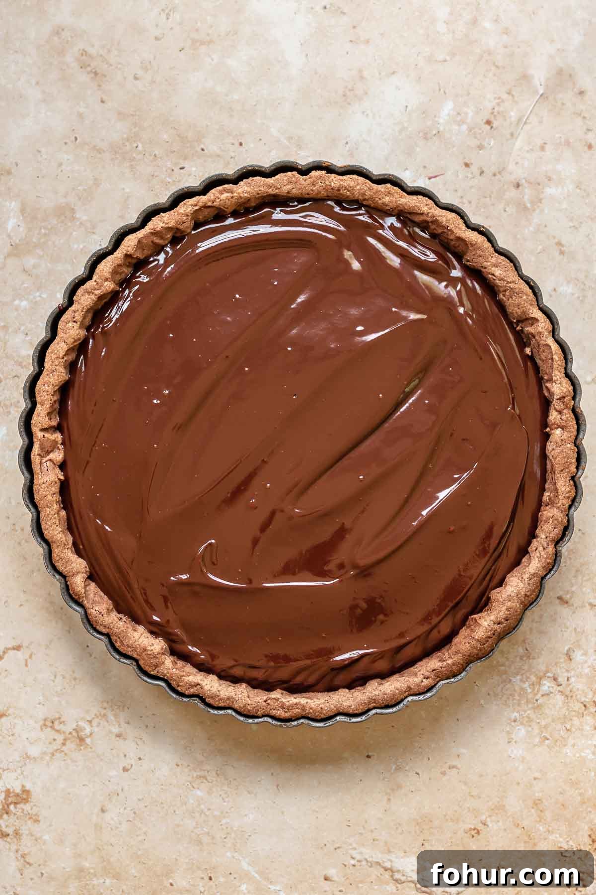 From Scratch Chocolate Raspberry Tart Recipe 8 Dark chocolate ganache in a tart shell spread smoothly.