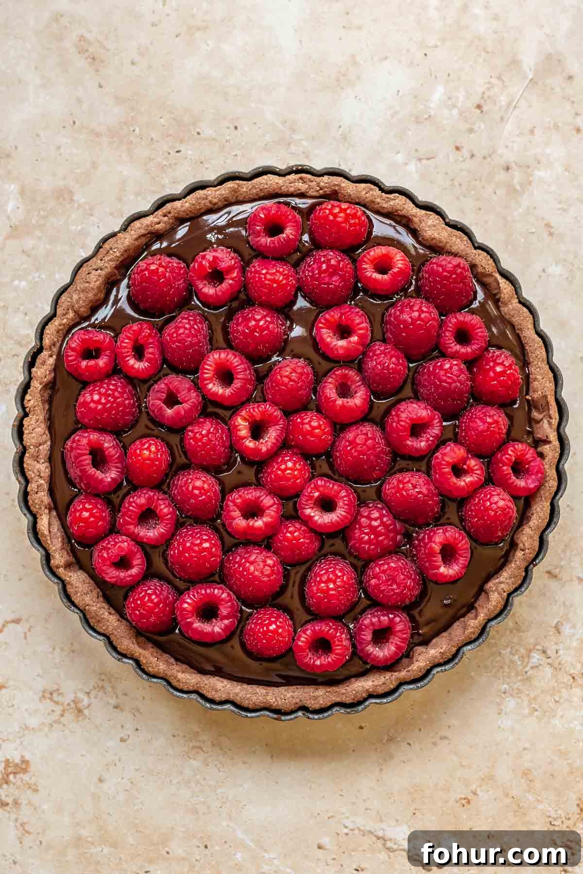 From Scratch Chocolate Raspberry Tart Recipe 9 Raspberries pressed into chocolate ganache in a tart.