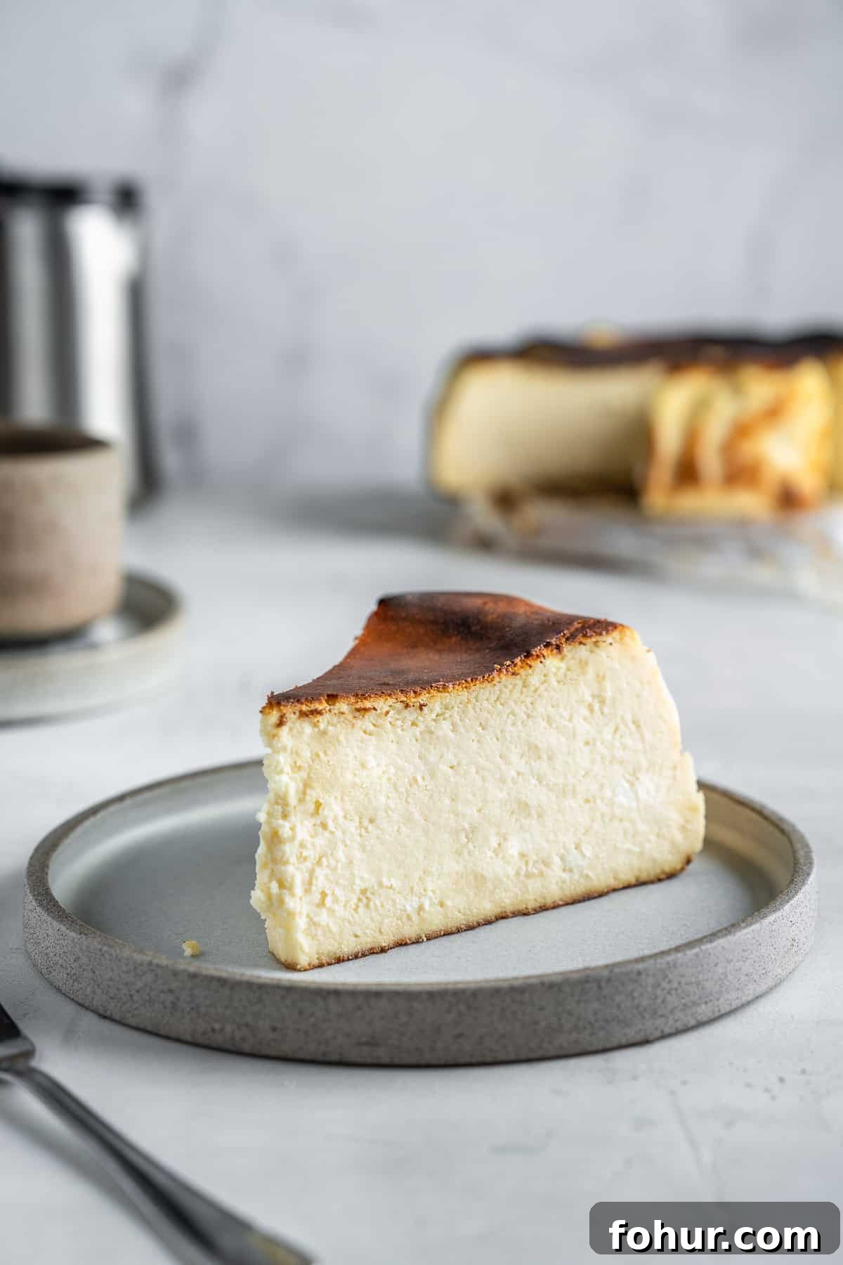 Slice of san Sebastian cheesecake on a dessert plate.