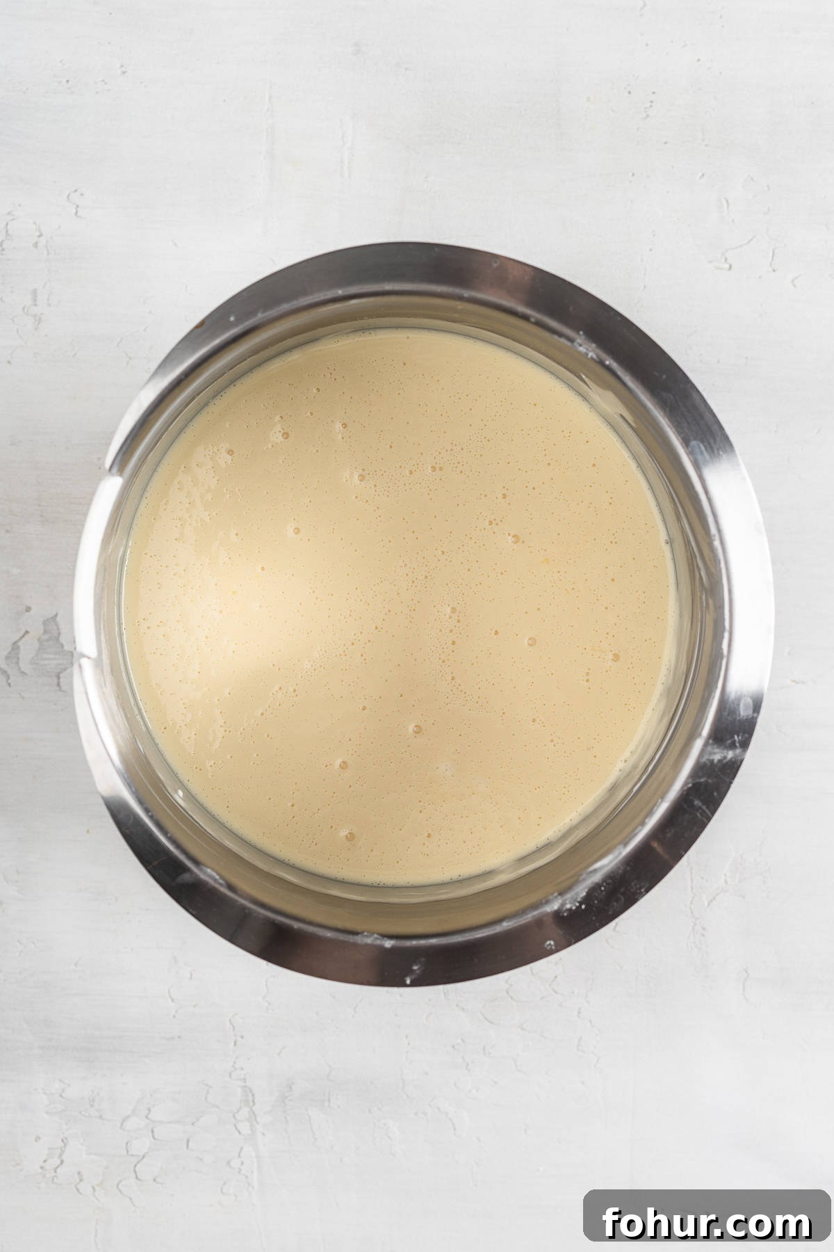 Cream cheese and sugar mixture in a bowl.