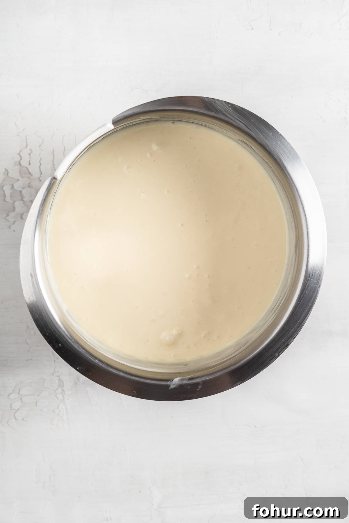 Cheesecake batter in a mixing bowl.