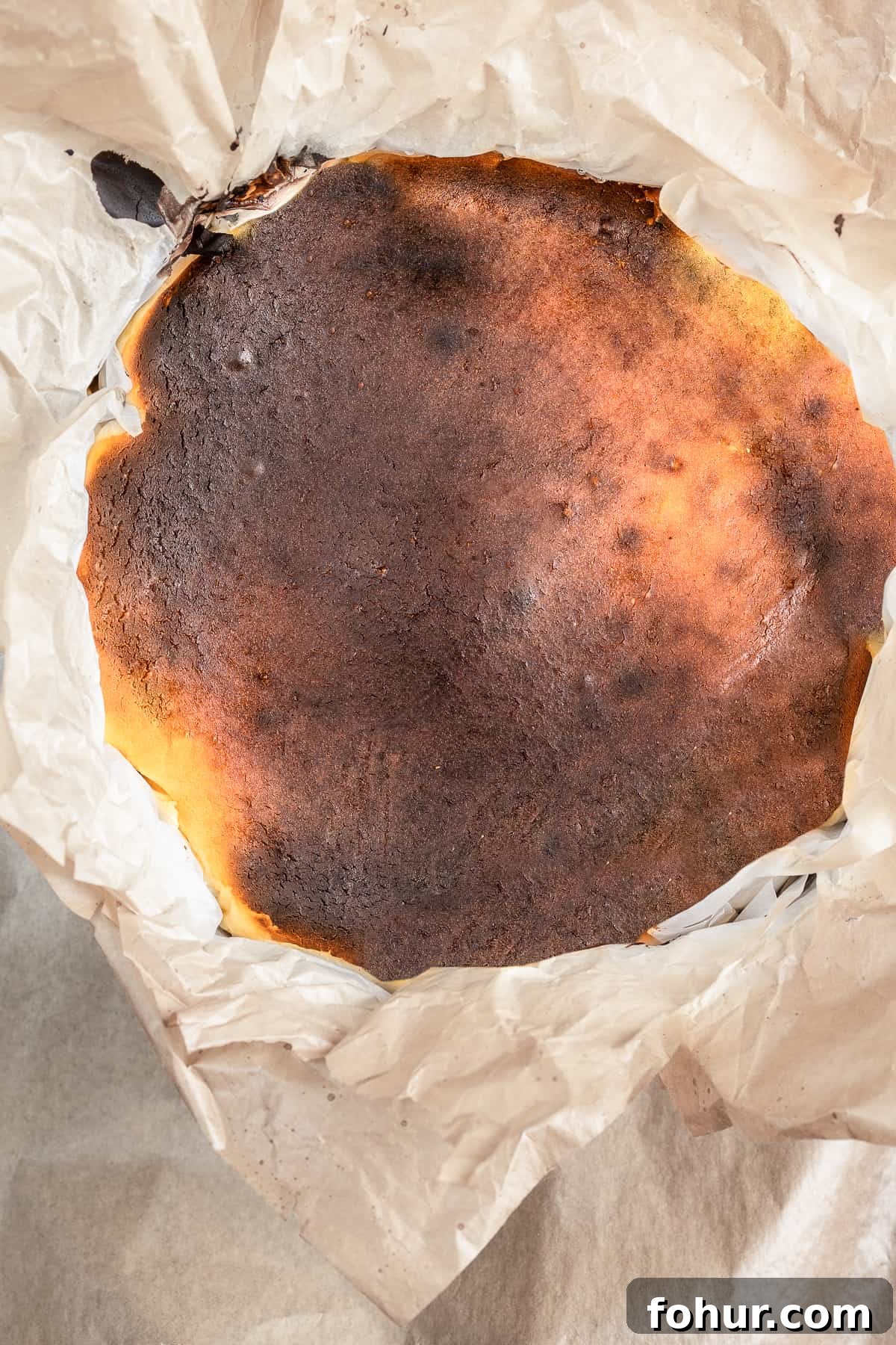 Baked burnt cheesecake in a baking mold.