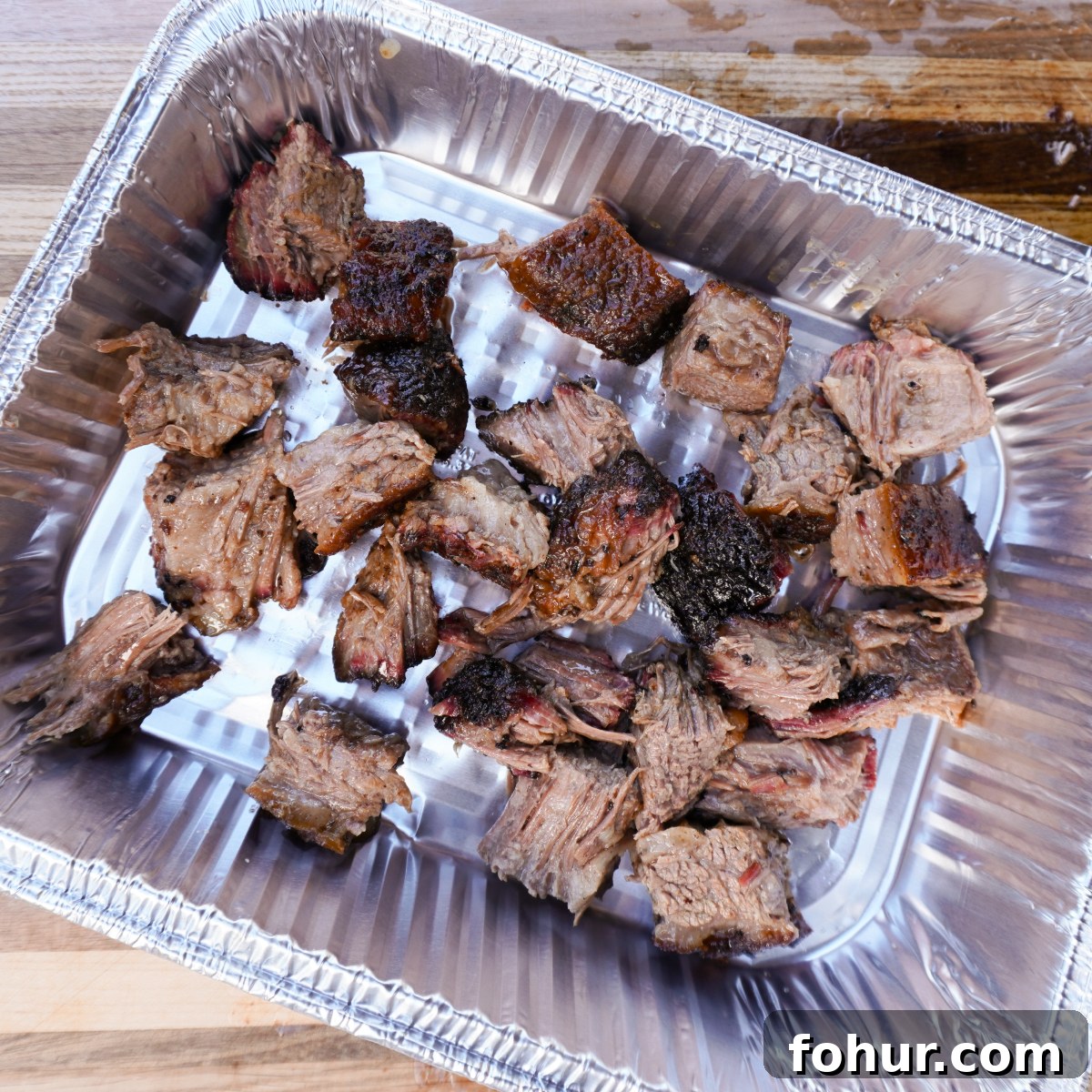 Smoky Brisket Burnt Ends Recipe 3 cubed brisket in foil pan.