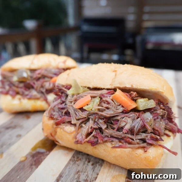 shredded italian beef sandwich on a cutting board.