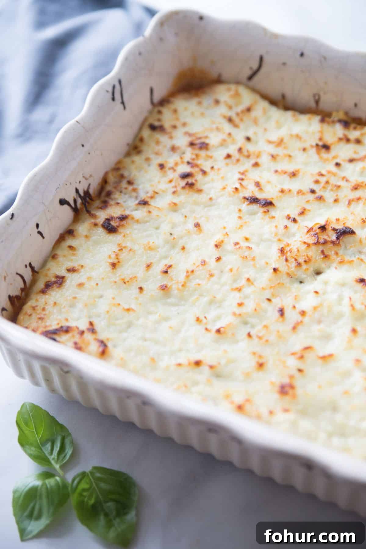 Low-Carb Spaghetti Squash Lasagna Recipe 10 Baked Spaghetti Squash Lasagna in a white ceramic baking dish.