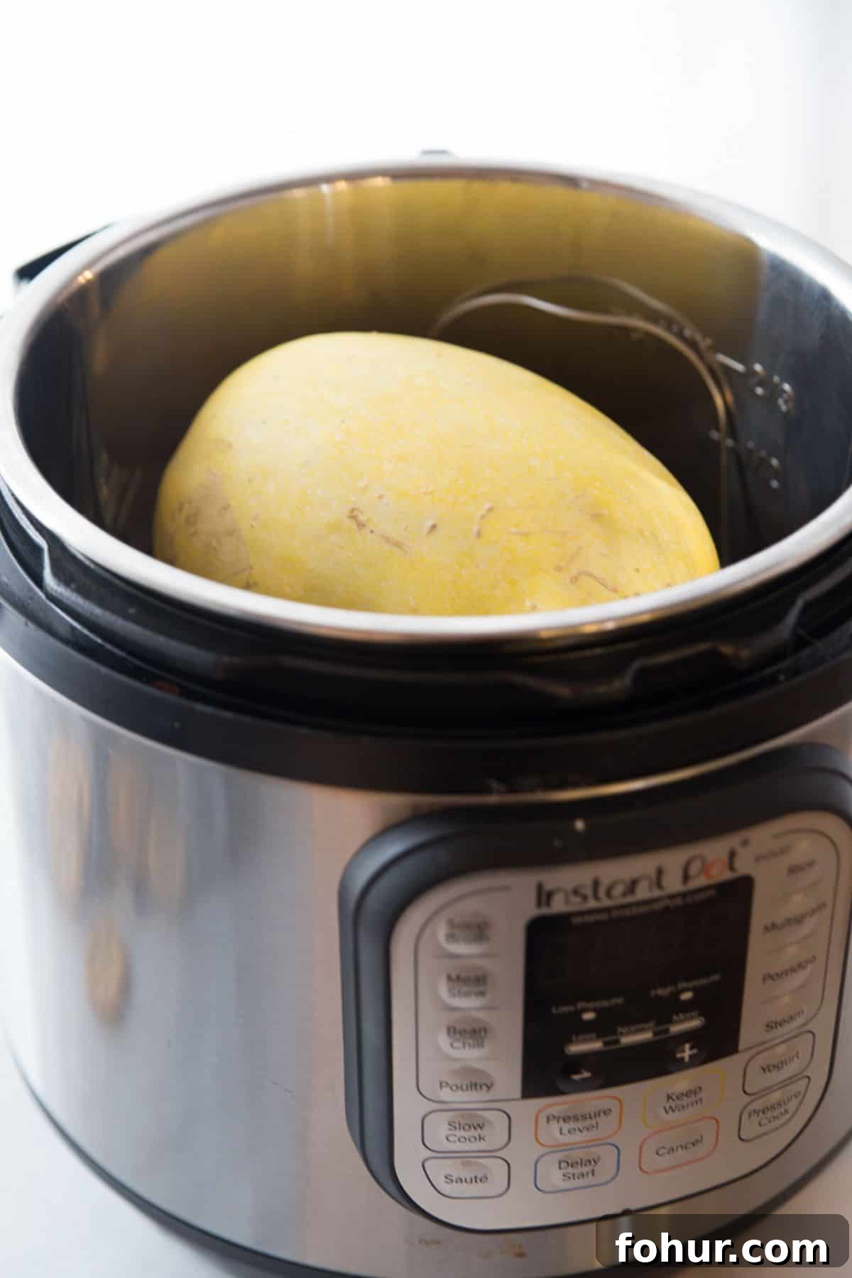 Low-Carb Spaghetti Squash Lasagna Recipe 4 An instant pot with a whole, uncooked spaghetti squash.