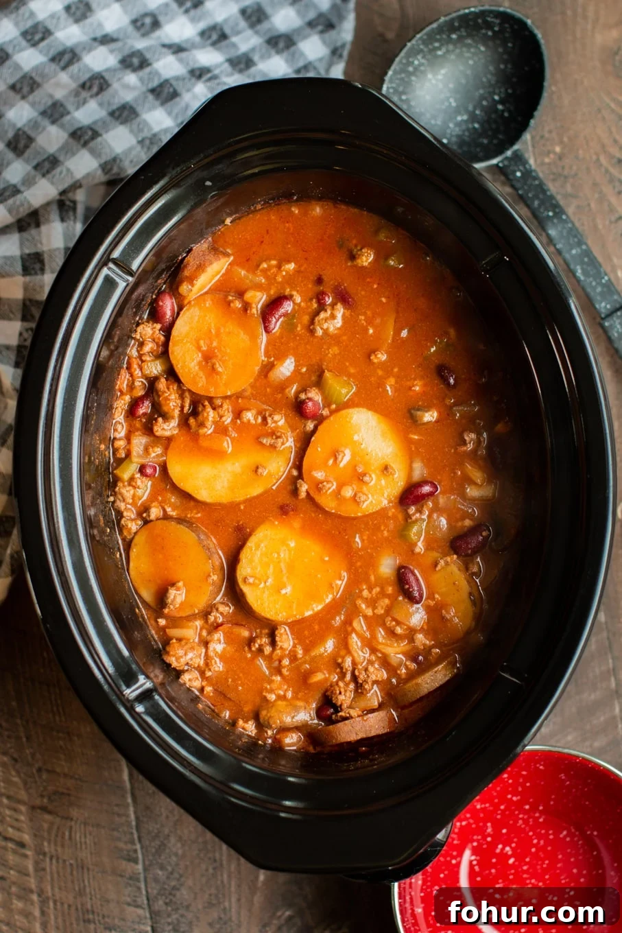 Shipwreck Stew Recipe: Rustic Seafood and Root Vegetable Soup 2 tomato based soup with sliced potatoes, kidney beans and ground beef in a slow cooker.