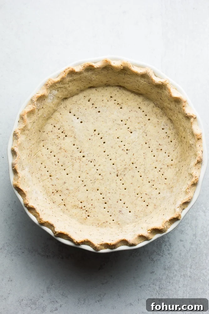 Flaky Vegan Gluten-Free Oil-Free Pie Crust Recipe 2 cooked pie crust on a grey background with fork holes