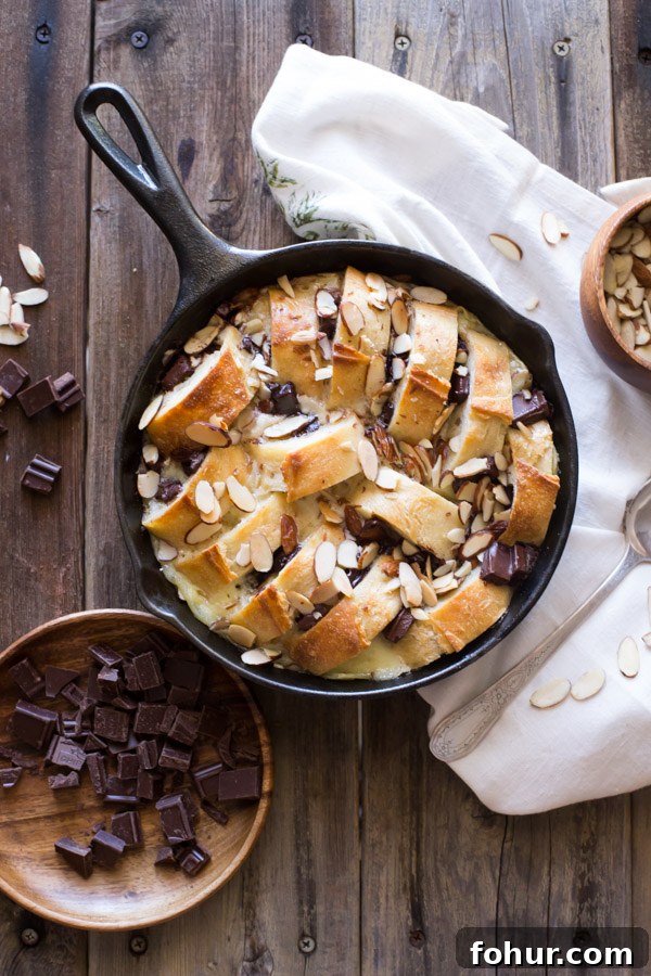 How to Clean a Cast Iron Skillet Without Stripping Seasoning 11 Chocolate Almond Bread Pudding in a cast iron skillet, with chopped chocolate and slivered almonds next to it.