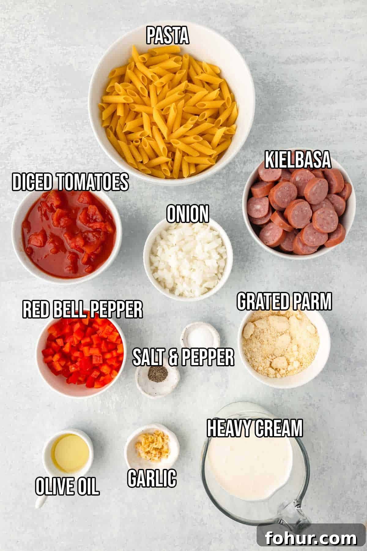 One-Pot Creamy Kielbasa and Smoked Sausage Pasta 3 Creamy kielbasa pasta ingredients: penna pasta, kielbasa, olive oil, onion, red bell pepper, garlic, diced tomatoes, heavy cream, parmesan, salt and pepper.