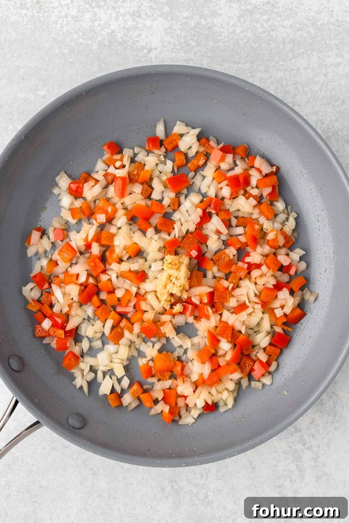 One-Pot Creamy Kielbasa and Smoked Sausage Pasta 5 The veggies are cooked until tender in a large skillet.