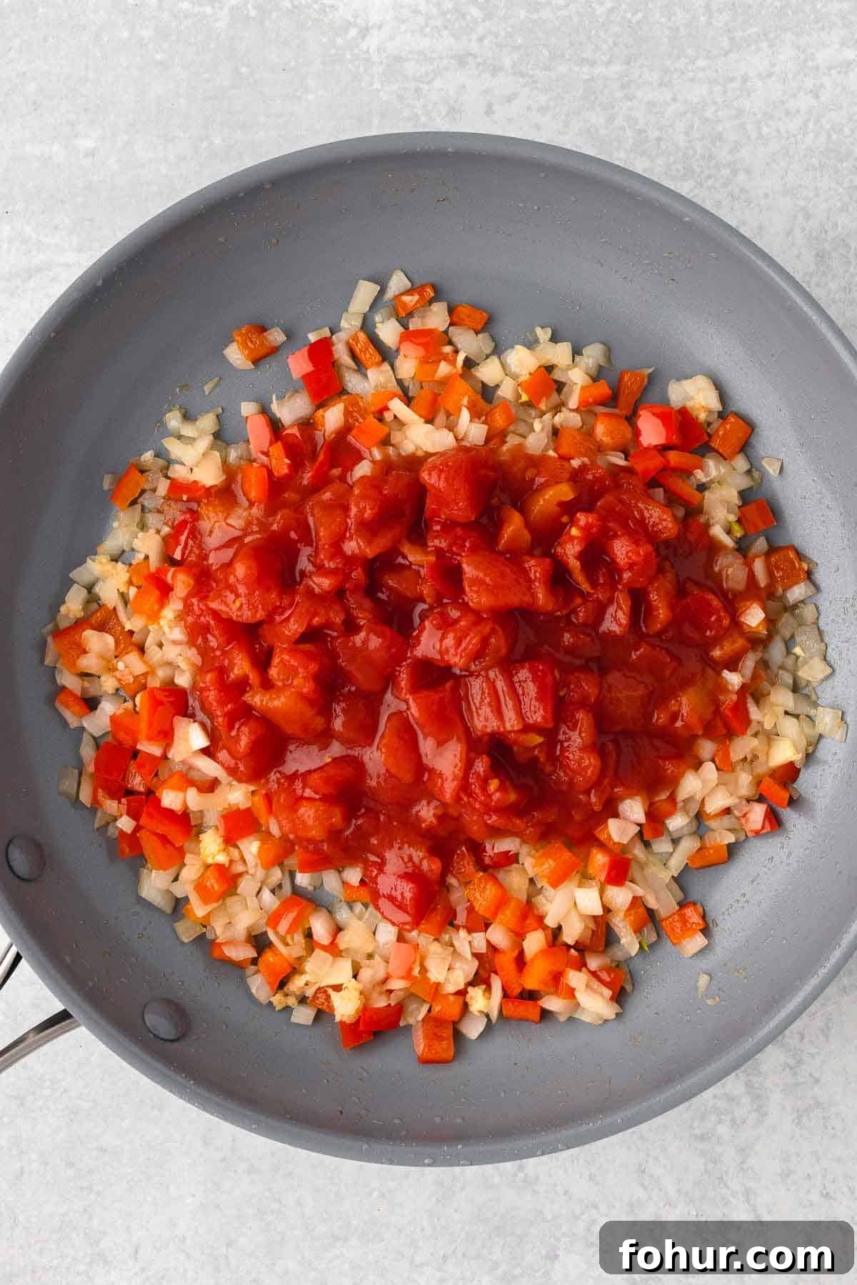 One-Pot Creamy Kielbasa and Smoked Sausage Pasta 6 Diced tomatoes with their juice are added to the large skillet with the cooked veggies.