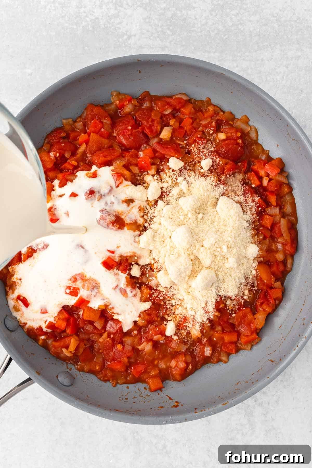 One-Pot Creamy Kielbasa and Smoked Sausage Pasta 7 Heavy cream and parmesan are added to the tomato sauce in the large skillet.