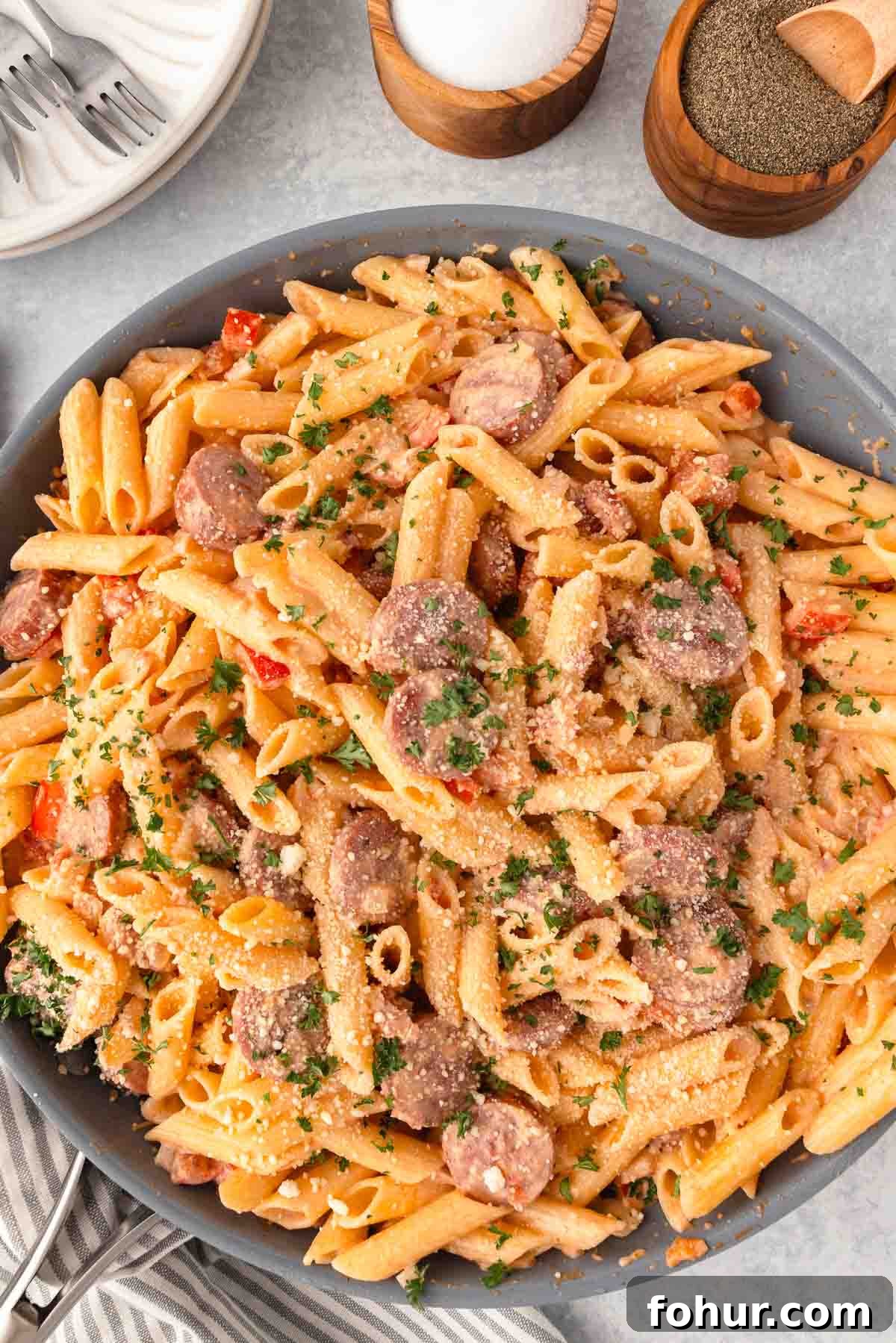 One-Pot Creamy Kielbasa and Smoked Sausage Pasta 10 Kielbasa pasta with penne, diced pepper, sliced smoked sausage, parmesan, and a cream sauce in a large skillet.