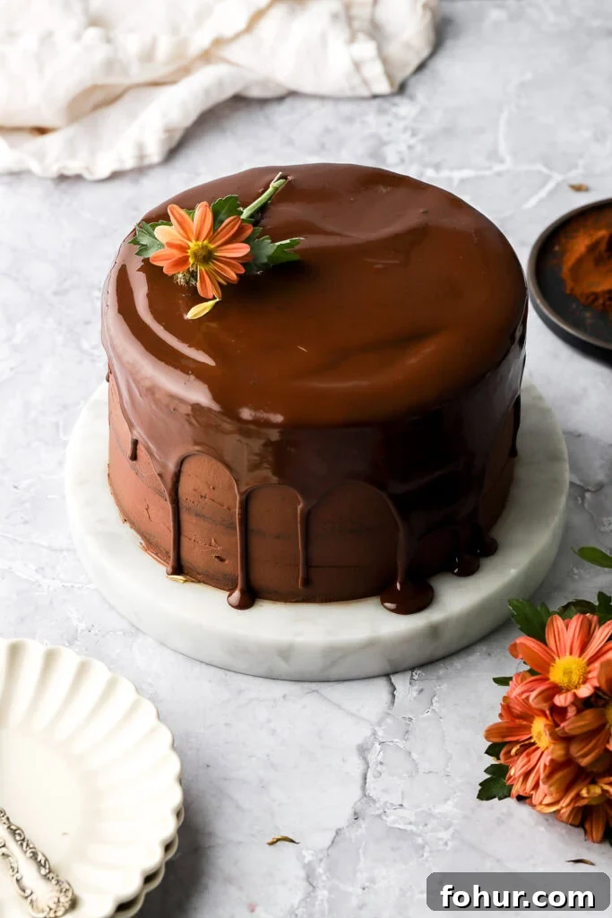 Decadent Chocolate Ganache Cake Recipe 8 Finished chocolate ganache cake with chocolate drip and a flower on top